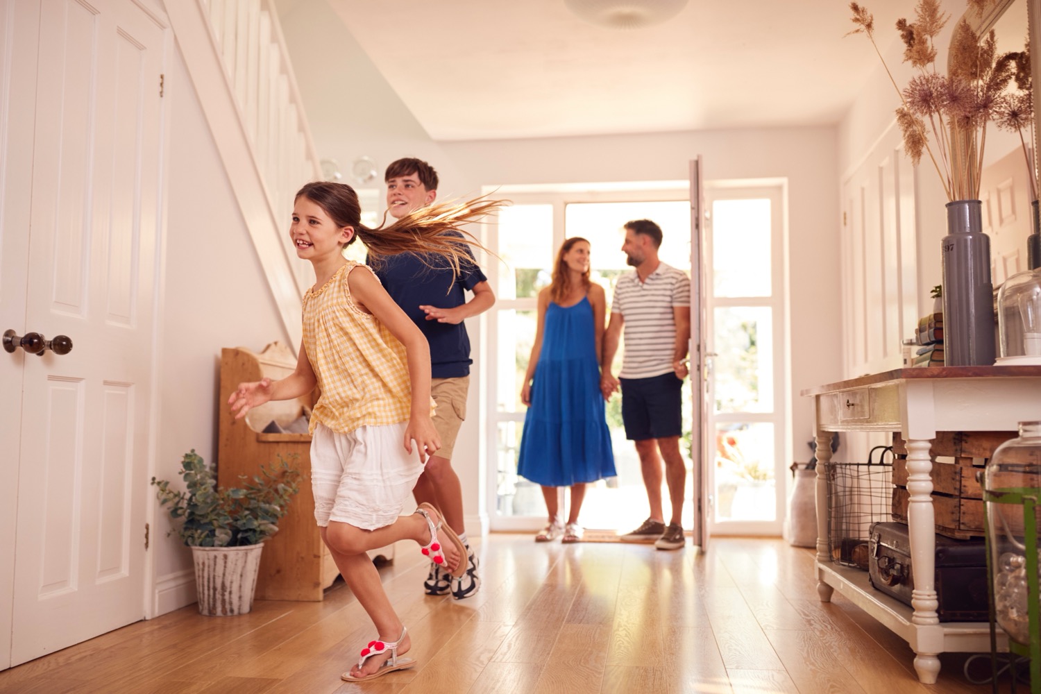 Kids running excitedly into a cool home during a hot summer day
